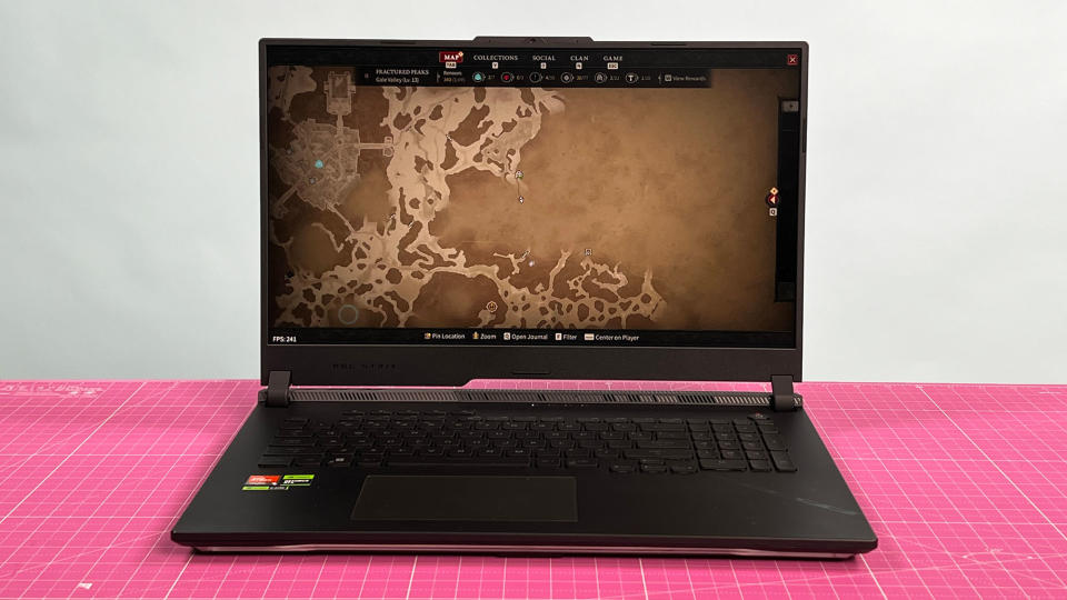 An Asus ROG Strix Scar 17 (2023) on a desk with a pink desk mat