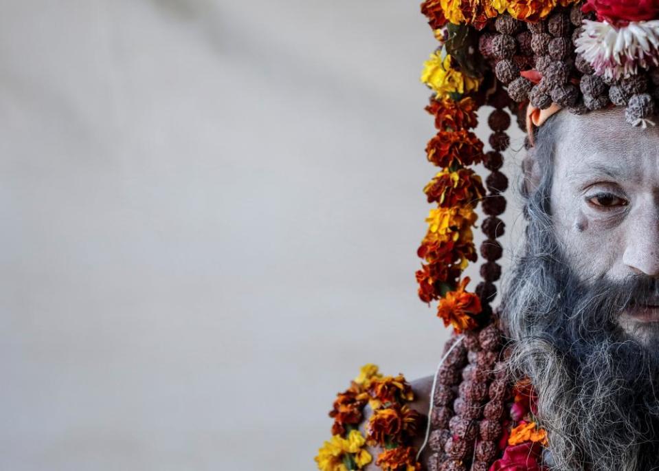 A Naga Sadhu or Hindu holy man waits for devotees inside his camp.