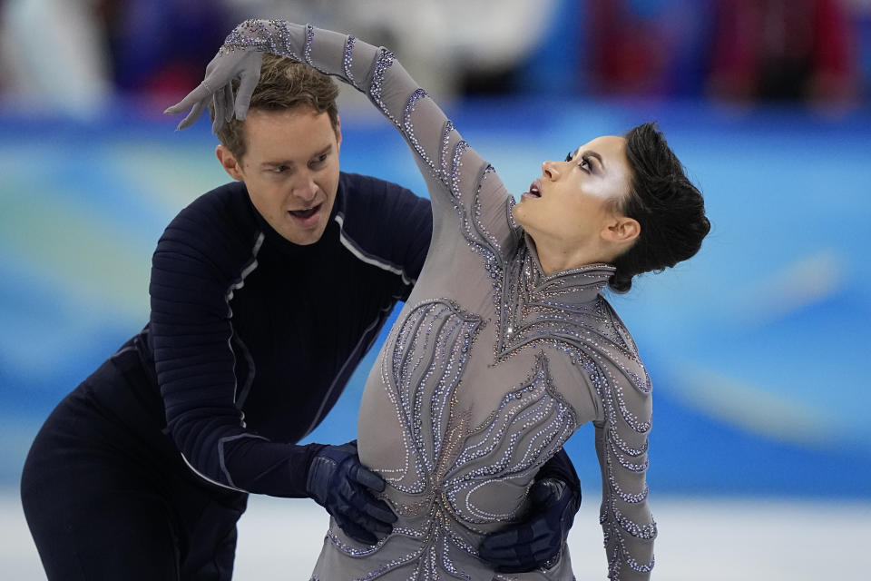 FILE - Madison Chock and Evan Bates, of the United States, compete in the team ice dance program during the figure skating competition at the 2022 Winter Olympics, Monday, Feb. 7, 2022, in Beijing. Eight months after finishing behind the Russians at the Winter Games, the U.S. team has yet to receive its medals, or even know whether they will be silver or gold. (AP Photo/David J. Phillip, File)