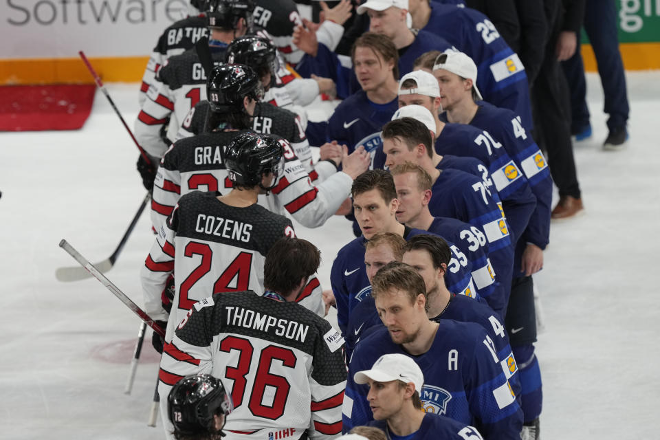 Team's Canada and Finland speak after the Hockey World Championship final match between Finland and Canada, Sunday May 29, 2022, in Tampere, Finland. Finland won 4-3 in overtime. (AP Photo/Martin Meissner)