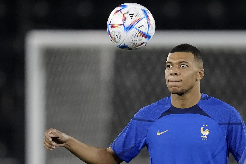 France's Kylian Mbappé eyes the ball during a training session in Doha, Qatar, Saturday, Dec. 3, 2022, on the eve of the World Cup soccer match between France and Poland. (AP Photo/Christophe Ena)