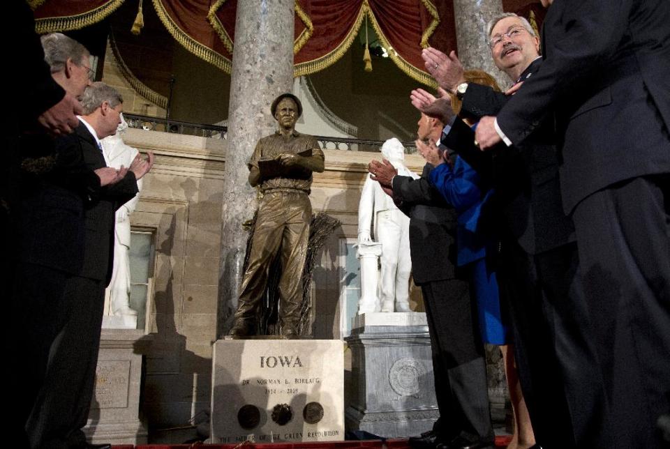 From left, Senate Minority Leader Mitch McConnell of Ky., Agriculture Secretary Tom Vilsack, House Speaker John Boehner of Ohio, Jeanie Borlaug Laube, daughter of Dr. Norman E. Borlaug, and Iowa Gov. Terry Branstad applaud after a statue of the late Dr. Norman E. Borlaug is unveiled in Statuary Hall on Capitol Hill in Washington, Tuesday, March 25, 2014. (AP Photo/Carolyn Kaster)
