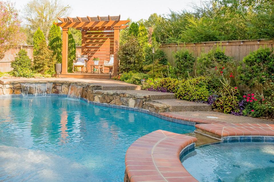 Plenty of seating, a spa, and a waterfall make the pool area a beautiful and delightful place to relax.