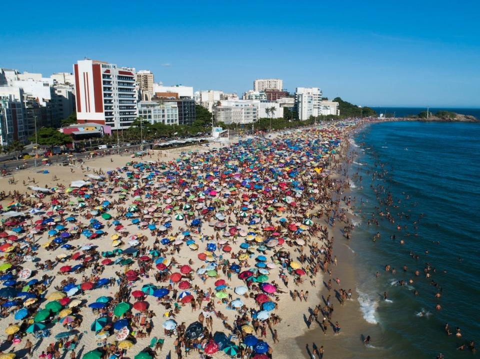 Beachgoers crowd Arpoador Beach in Brazil on January 17, 2021.