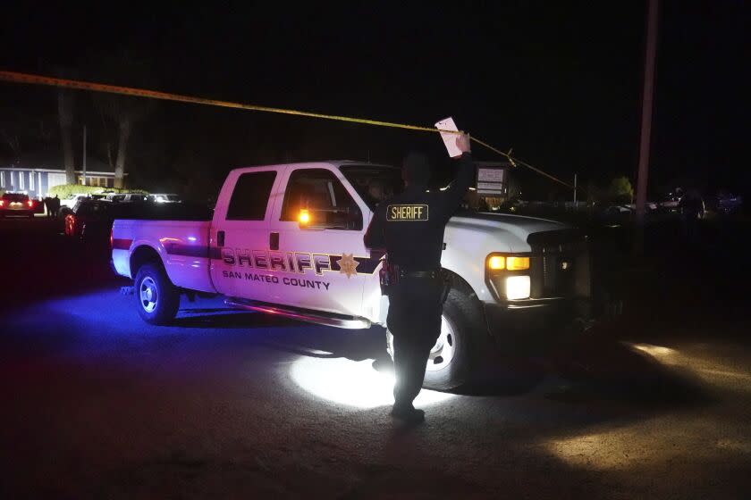 A Sheriff's vehicle is driven under police tape near the scene of a shooting Monday, Jan. 23, 2023, in Half Moon Bay, Calif. Multiple people were killed in two related shootings Monday at a mushroom farm and a trucking firm in a coastal community south of San Francisco, and officials say a suspect is in custody. (AP Photo/Jeff Chiu)