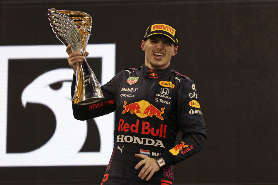 Red Bull driver Max Verstappen of the Netherlands celebrates on the podium after becoming F1 drivers world champion after winning the Formula One Abu Dhabi Grand Prix in Abu Dhabi, United Arab Emirates, Sunday, Dec. 12. 2021. (AP Photo/Kamran Jebreili, Pool)