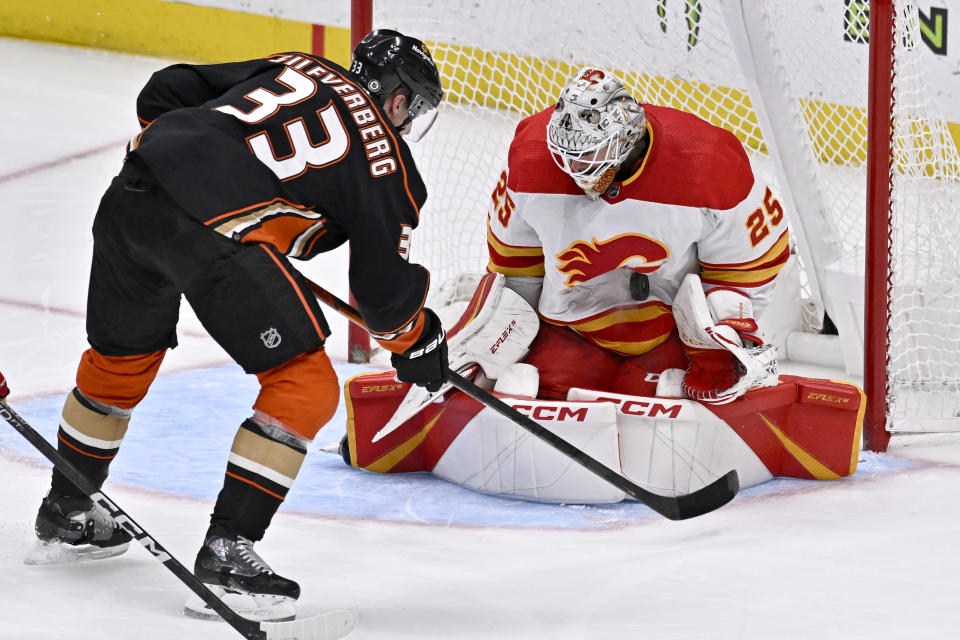 Calgary Flames goaltender Jacob Markstrom, right, stops a shot by Anaheim Ducks right wing Jakob Silfverberg during the third period of an NHL hockey game in Anaheim, Calif., Friday, Dec. 23, 2022. (AP Photo/Alex Gallardo)