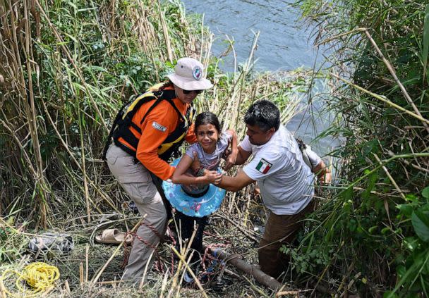 PHOTO: A migrant girls who swam back to Mexico with her mother after reaching the US bank of the Rio Bravo river and being stopped by members of the US National Guard in Matamoros, state of Tamaulipas, Mexico, on May 10, 2023. (Alfredo Estrella/AFP via Getty Images)