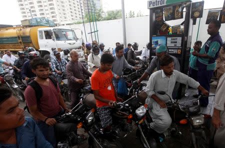 Customers buy petrol at a petrol station in Karachi, Pakistan July 26, 2017. REUTERS/Akhtar Soomro