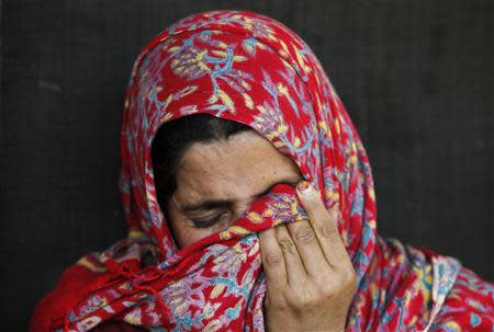 Saheema Akhtar, wife of Mohammed Amin Pandith, a village council head, who was killed by militants, weeps inside her house in Gulzarpora, south of Srinagar April 23, 2014. REUTERS/Danish Ismail