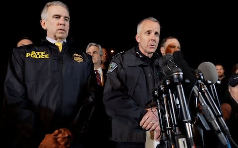  Austin Police Chief Brian Manley, right, stands with other members of law enforcement as he briefs the media - Credit: Eric Gay /AP