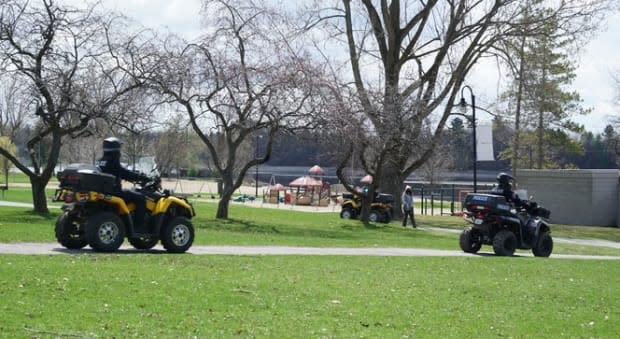 Police officers ride ATVs while patrolling Mooney's Bay park in Ottawa on April 17, 2021, during the COVID-19 pandemic.