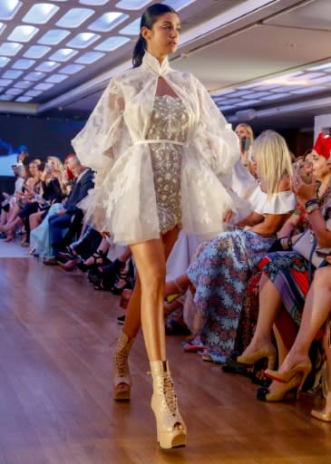 A model walks on the catwalk displaying designs by Amato Couture during Arab Fashion Week in the Gulf emirate of Dubai on May 9, 2018