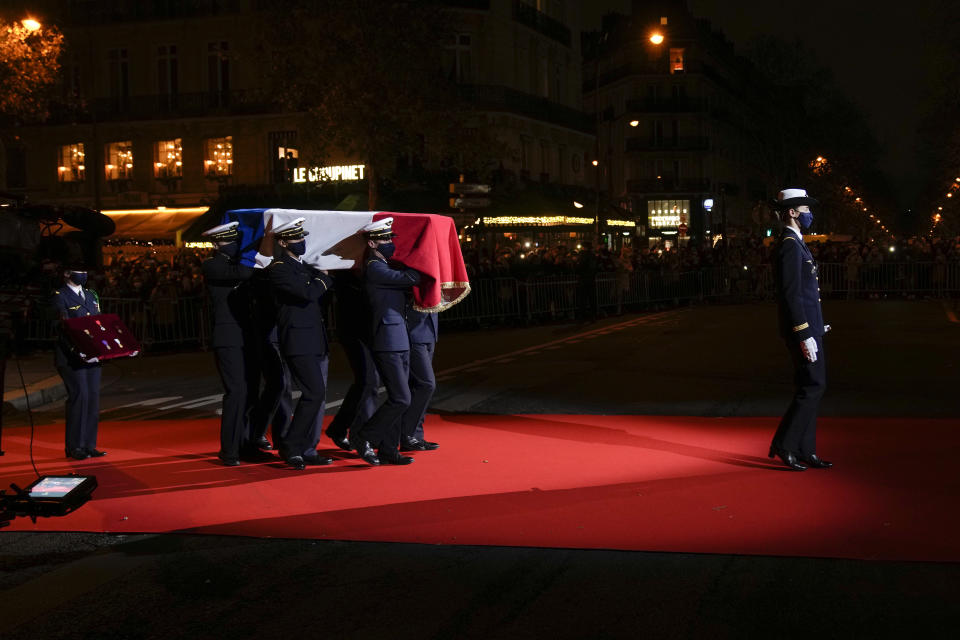 The coffin with soils from the U.S., France and Monaco is carried towards the Pantheon monument, rear, in Paris, France, Tuesday, Nov. 30, 2021, where Josephine Baker is to symbolically be inducted, becoming the first Black woman to receive France's highest honor. Her body will stay in Monaco at the request of her family. (AP Photo/Christophe Ena)