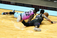 Miami Heat forward Jimmy Butler (22) and Philadelphia 76ers forward Danny Green (14) go for a loose ball during the second half of an NBA basketball game Thursday, May 13, 2021, in Miami. (AP Photo/Lynne Sladky)