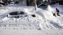 Scott Asperheim runs his snowblower to clear the sidewalk around his home from several feet of snow after a snowstorm in Duluth, Minnesota December 5, 2013. People from Texas to New York were bundling up December 5 against winter weather that closed schools and businesses, blanketed roads and power lines with ice and threatened to disrupt travel across a wide swath of the United States. REUTERS/Bob King/Duluth News Tribune