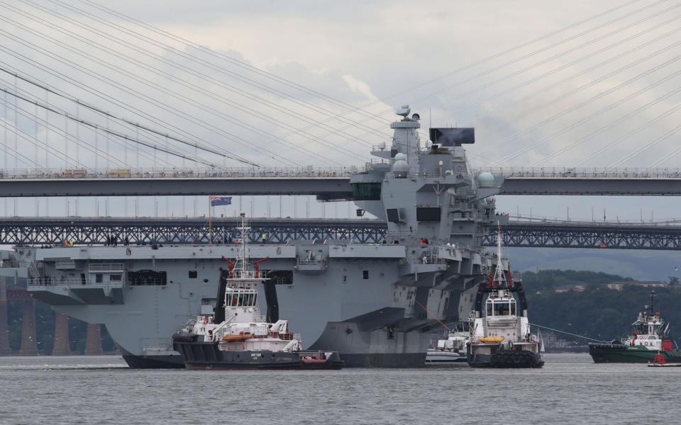 HMS Queen Elizabeth, one of two new aircraft carriers for the Royal Navy, on the Firth of Forth after leaving the Rosyth dockyard near Edinburgh to begin her sea worthiness trials. - Credit: Andrew Milligan/PA