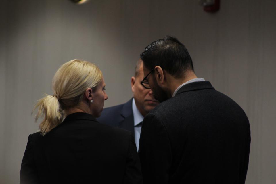 Gurpreet Singh, 41, speaking with his attorneys after being sentenced to death in Butler County Common Pleas Court for the murders of his wife and her family in April 2019.