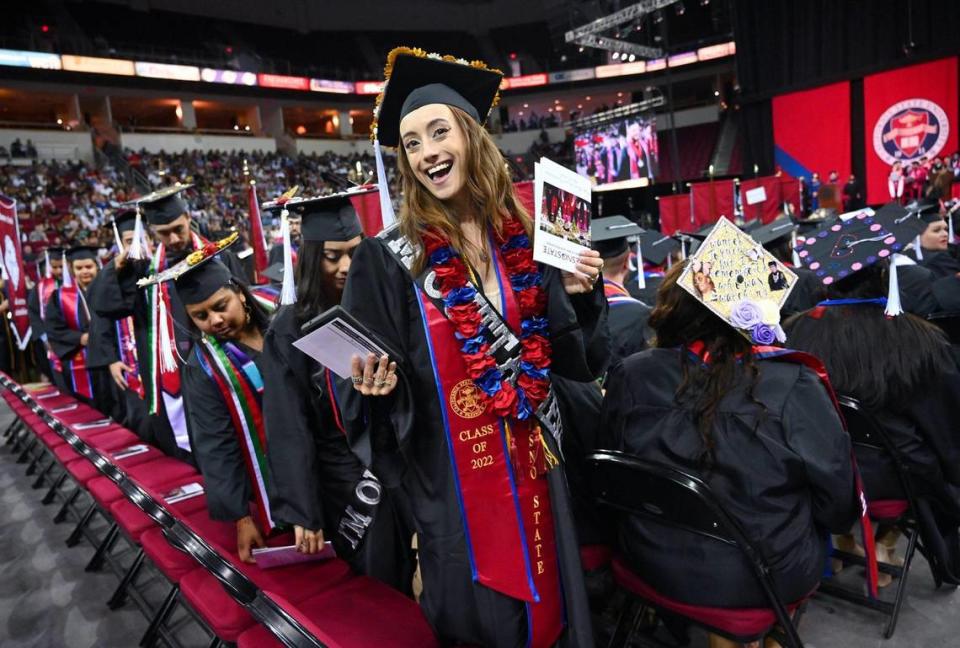 Siena Simas, center, from the Department of Theatre and Dance takes her seat at Fresno State’s College of Arts and Humanities commencement exercise Friday, May 20, 2022 in Fresno.