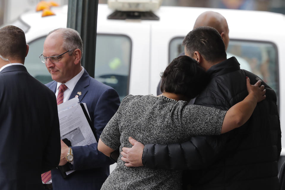 New Orleans Mayor Latoya Cantrell comforts the brother of one of the deceased workers as Louisiana Gov. John Bel Edwards walks away after giving his condolences, near the Hard Rock Hotel, Thursday, Oct. 17, 2019, in New Orleans. The 18-story hotel project that was under construction collapsed last Saturday, killing three workers. Two bodies remain in the wreckage. (AP Photo/Gerald Herbert)