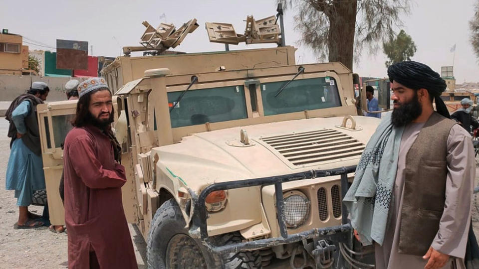 Taliban with a captured vehicle