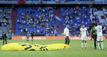 Germany's Antonio Ruediger, right, and Germany's Robin Gosens speak to a protestor who landed on the pitch before the Euro 2020 soccer championship group F match between France and Germany at the Allianz Arena stadium in Munich, Tuesday, June 15, 2021. (Matthias Hangst/Pool via AP)