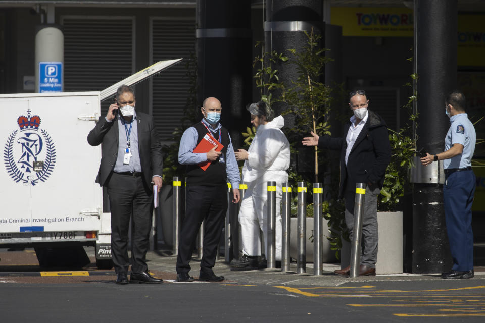 Police and forensic staff stand outside a supermarket in Auckland, New Zealand, Saturday, Sept. 4, 2021.New Zealand authorities say they shot and killed a violent extremist, Friday, Sept. 3 after he entered the supermarket and stabbed and injured six shoppers. Prime Minister Jacinda Ardern described Friday's incident as a terror attack. (AP Photo/Brett Phibbs)