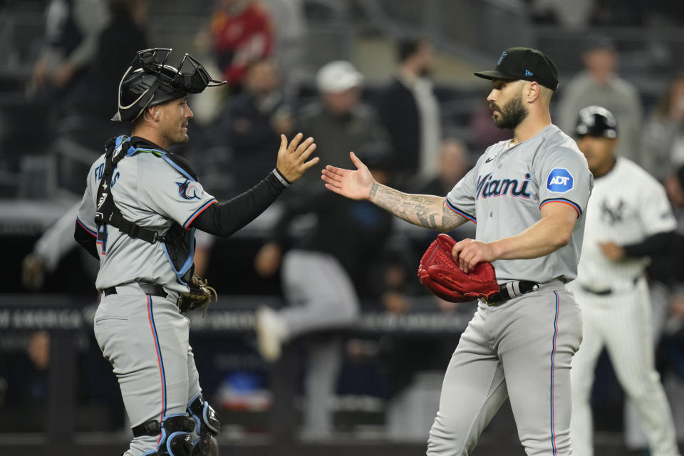 Miami Marlins pitcher Tanner Scott, right, celebrates with catcher Nick Fortes after the baseball game against the New York Yankees at Yankee Stadium, Wednesday, April 10, 2024, in New York. The Marlins defeated the Yankees 5-2. (AP Photo/Seth Wenig)