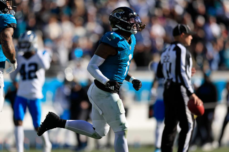 Jacksonville Jaguars running back Travis Etienne Jr. (1) runs to the sideline after scoring a touchdown during the third quarter of a regular season NFL football matchup Sunday, Dec. 31, 2023 at EverBank Stadium in Jacksonville, Fla. The Jacksonville Jaguars blanked the Carolina Panthers 26-0. [Corey Perrine/Florida Times-Union]