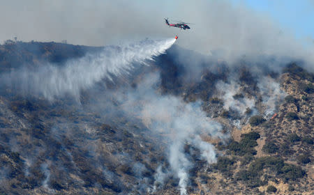 Firefighters continue to battle the Thomas fire , a wildfire near Fillmore, California, December 14, 2017. REUTERS/Gene Blevins