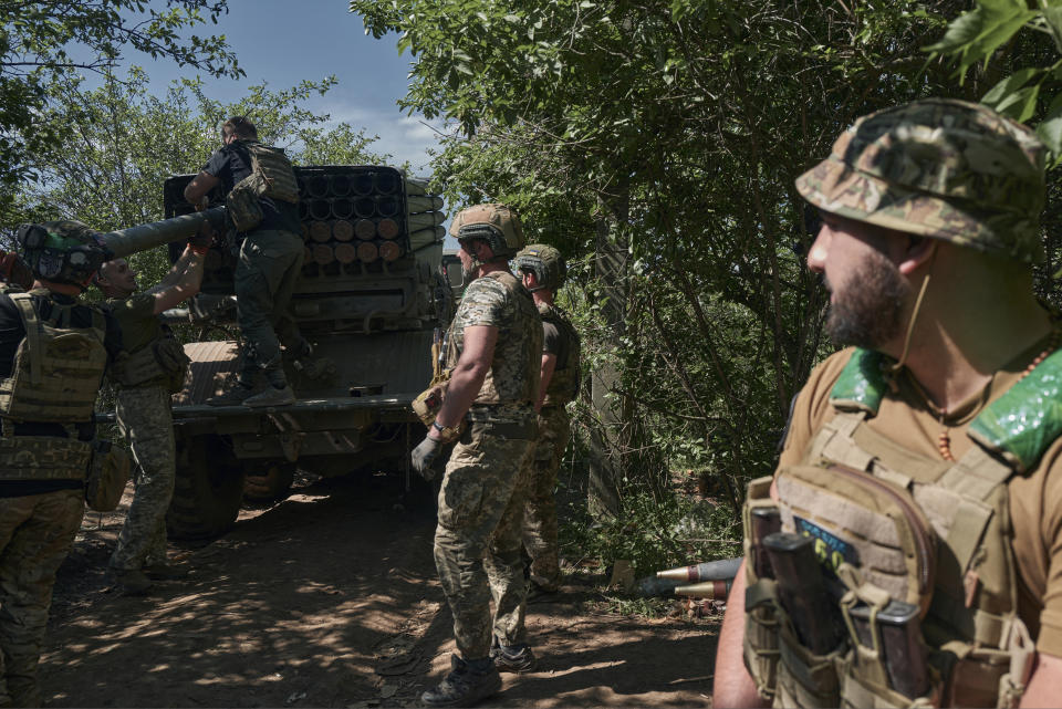 FILE - Ukrainian soldiers load rockets into a Grad multiple rocket launcher to fire towards Russian positions in the frontline near Bakhmut, Donetsk region, Ukraine, on May 17, 2023. When Russia invaded Ukraine in February 2022, Ukraine’s military was largely reliant on Soviet-era weaponry. While that arsenal helped Ukraine fend off an assault on the capital of Kyiv and prevent a total rout in the early weeks of the war, billions of dollars in military assistance has since poured into the country, including more modern Western-made weapons. (AP Photo/Libkos, File)