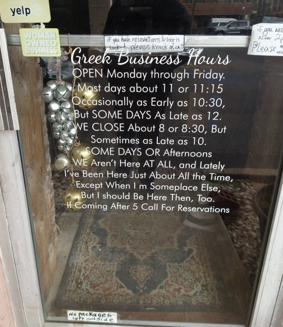 Business door sign with humorous hours of operation, indicating irregular and whimsical open times