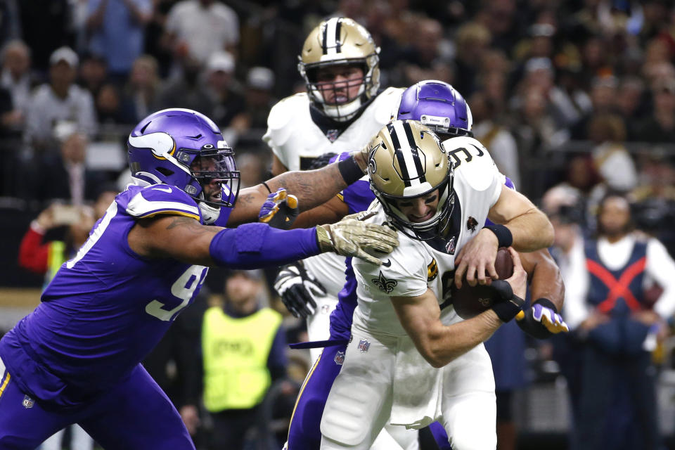 Minnesota Vikings defensive end Danielle Hunter tries to tackle New Orleans Saints quarterback Drew Brees (9) in the first half of an NFL wild-card playoff football game, Sunday, Jan. 5, 2020, in New Orleans. (AP Photo/Butch Dill)