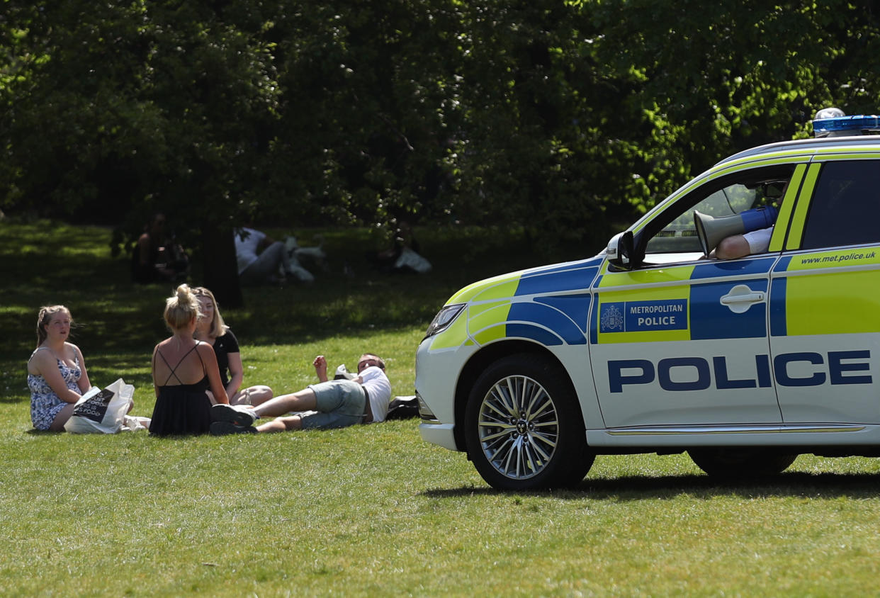 Police officers in a patrol car move sunbathers on in Greenwich Park, London, as the UK continues in lockdown to help curb the spread of the coronavirus. (Photo by Yui Mok/PA Images via Getty Images)