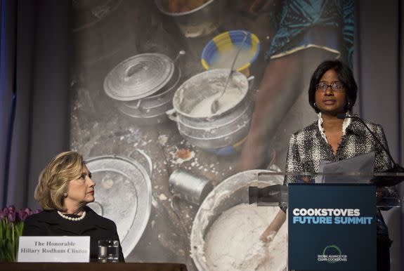 Hillary Clinton, left, listens as Radha Muthiah, executive director of the Global Alliance for Clean Cookstoves, speaks at a New York summit. Clinton launched the public-private initiative in 2010 as U.S. secretary of state.