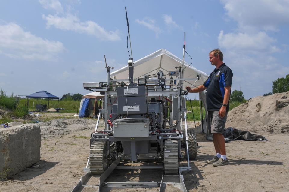 Todd Letcher, an associate professor of mechanical engineering at South Dakota State University and the project advisor for the SDSU team Space Trajectory's entry in NASA's Break the Ice Lunar Challenge, stands by the team's excavator in Brookings, South Dakota on Wednesday, Aug. 9, 2023.