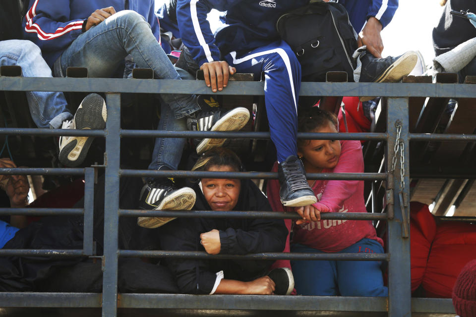 Central American migrants, part of the caravan hoping to reach the U.S. border, get a ride on a truck, in Celaya, Mexico, Sunday, Nov. 11, 2018. Local Mexican officials were once again Sunday helping thousands of Central American migrants find rides on the next leg of their journey toward the U.S. border. (AP Photo/Marco Ugarte)