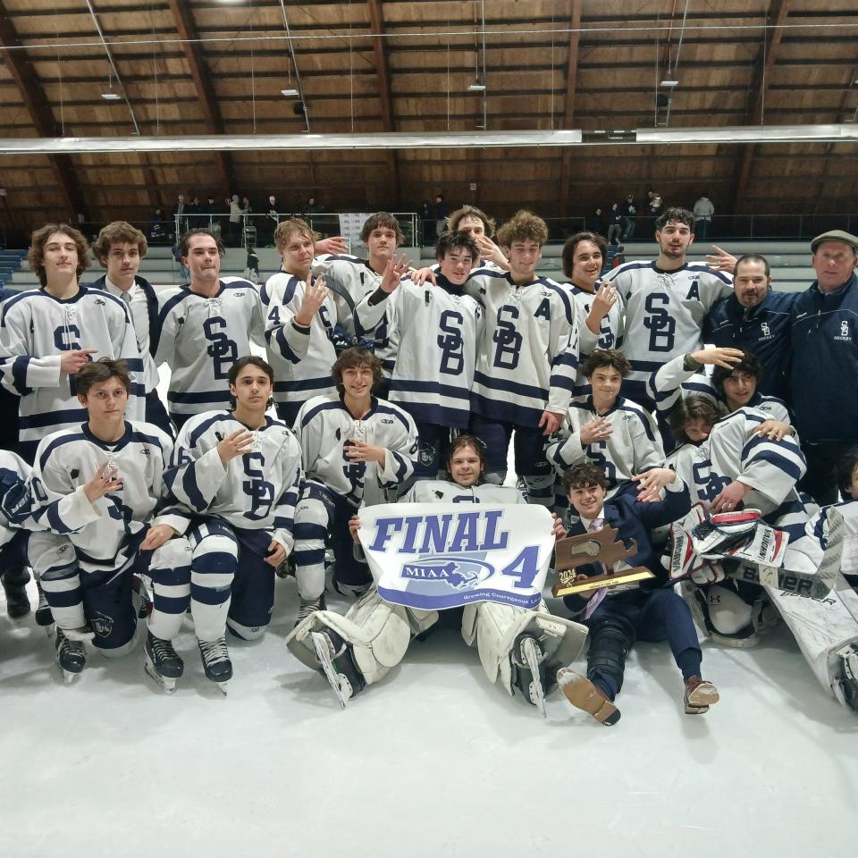 Members of the Somerset Berkley ice hockey team gathering around for a team photo with the Final 4 banner after the Raiders blanked West Springfield on Thursday, 3-0, in the Division 3 Elite 8 contest at Loring Arena in Framingham March 7, 2024.