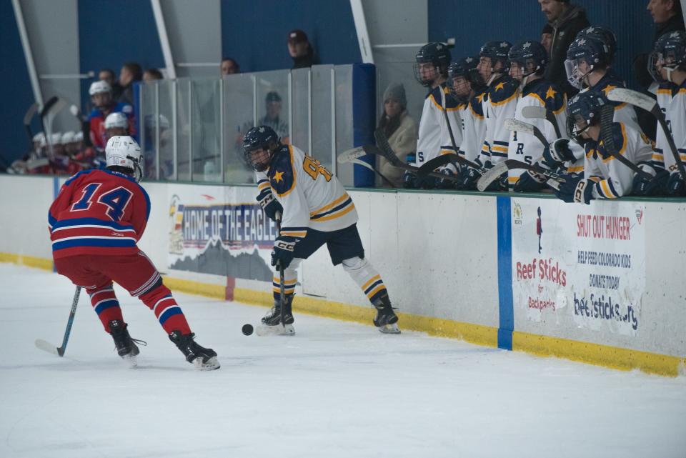 Poudre School District ice hockey player Haden Williamson (95) battles for the puck with Cherry Creek's Zane Miller (14) during a game against Cherry Creek on Friday, January 26, 2024, at NoCo Ice Center in Windsor, Colo.