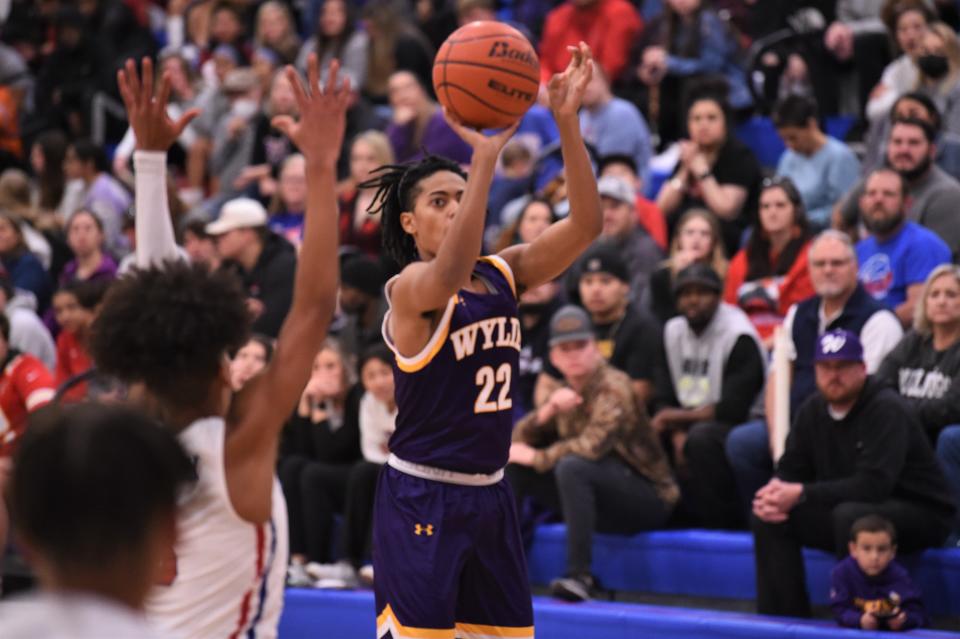 Wylie's Kazion Brown (22) takes a shot during Friday's Southtown Showdown against Cooper at Cougar Gym on Jan. 21, 2022. The Bulldogs kept the game close before falling 54-41.