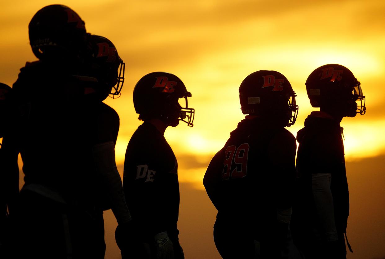 September 8, 2022; Phoenix, Arizona; USA; Desert Edge players take the field as the sun sets during a game at Barry Goldwater High School.