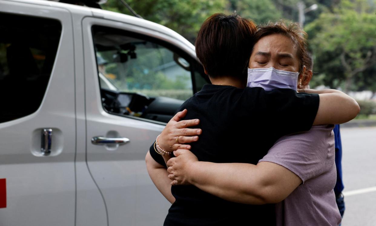 <span>Relatives hug as they are reunited after the earthquake in Hualien. One of them was rescued from a remote area.</span><span>Photograph: Tyrone Siu/Reuters</span>