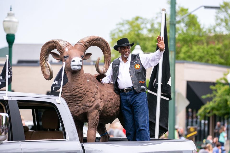 Fort Smith Mayor George McGill waves at the crowd gathered along Garrison Avenue during the Old Fort Days Parade in Fort Smith on May 31, 2021.