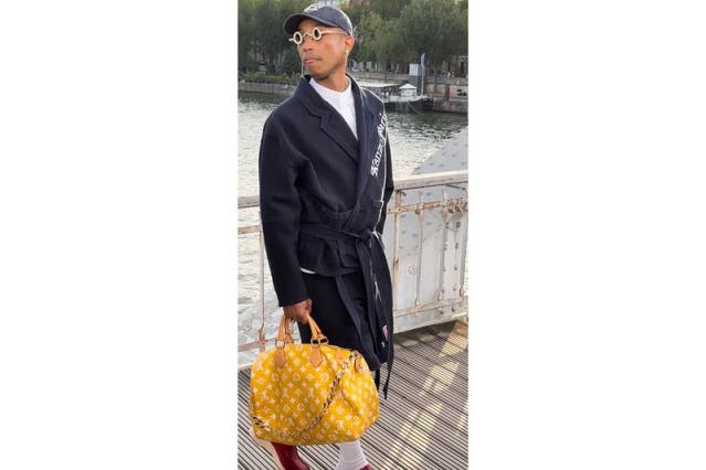 Pharrell Williams takes a victory lap at the Loewe show in Paris,  accessorising with his Millionaire bag