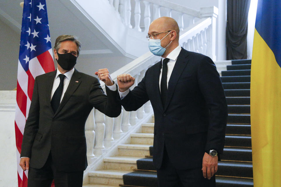 U.S. Secretary of State Antony Blinken, left, and Ukraine's Prime Minister Denis Shmygal greet each other prior to their talks in Kyiv, Ukraine, Thursday, May 6, 2021. (AP Photo/Efrem Lukatsky, Pool)