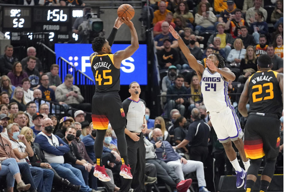 Utah Jazz guard Donovan Mitchell (45) shoots as Sacramento Kings guard Buddy Hield (24) defends in the first half during an NBA basketball game Tuesday, Nov. 2, 2021, in Salt Lake City. (AP Photo/Rick Bowmer)