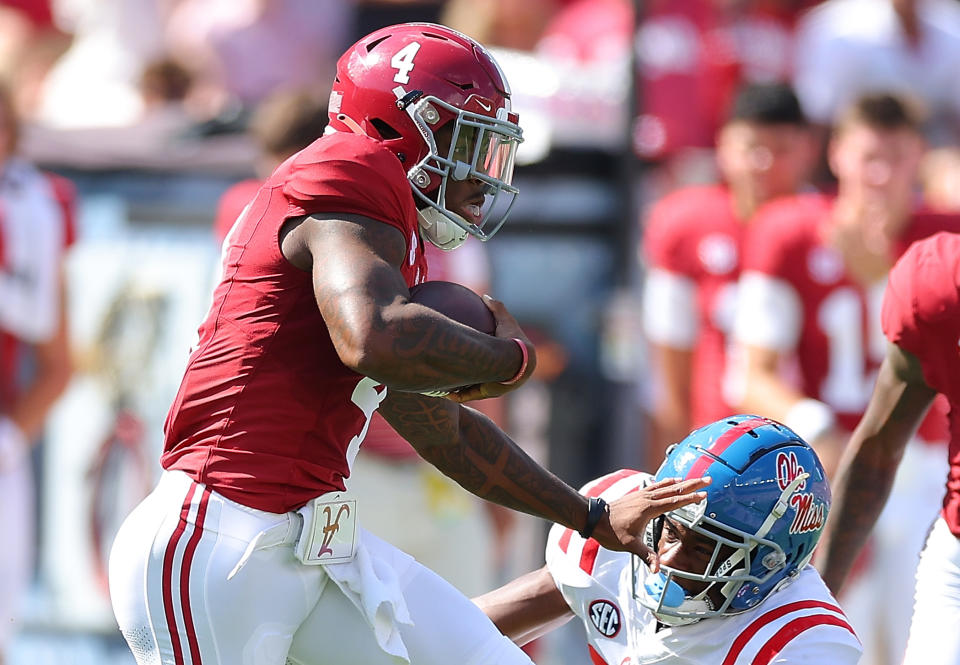 TUSCALOOSA, ALABAMA - SEPTEMBER 23:  Jalen Milroe #4 of the Alabama Crimson Tide rushes and stiff arms Trey Washington #25 of the Mississippi Rebels during the first quarter at Bryant-Denny Stadium on September 23, 2023 in Tuscaloosa, Alabama. (Photo by Kevin C. Cox/Getty Images)