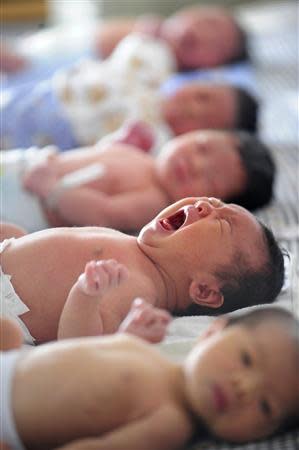 Newborn babies are pictures at a hospital in Hefei, Anhui province in this August 8, 2008 file photo. REUTERS/Stringer/Files