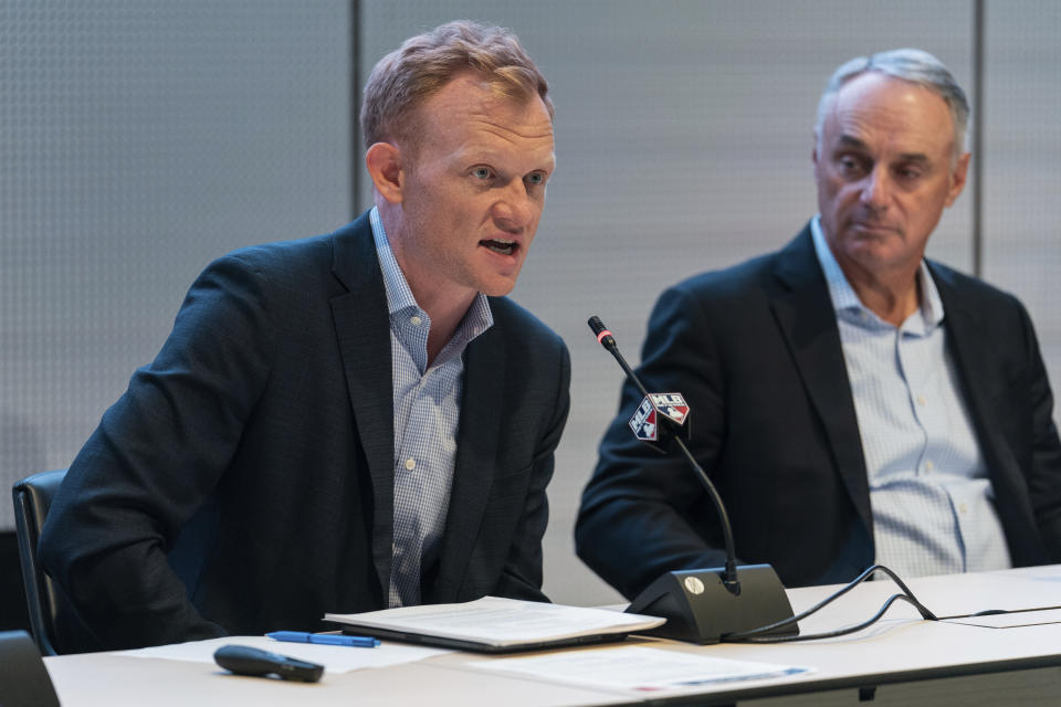 Major League Baseball Executive Vice President Morgan Sword, left, speaks during a news conference at Major League Baseball's headquarters on Friday, Sept. 9, 2022. (AP Photo/Jeenah Moon)