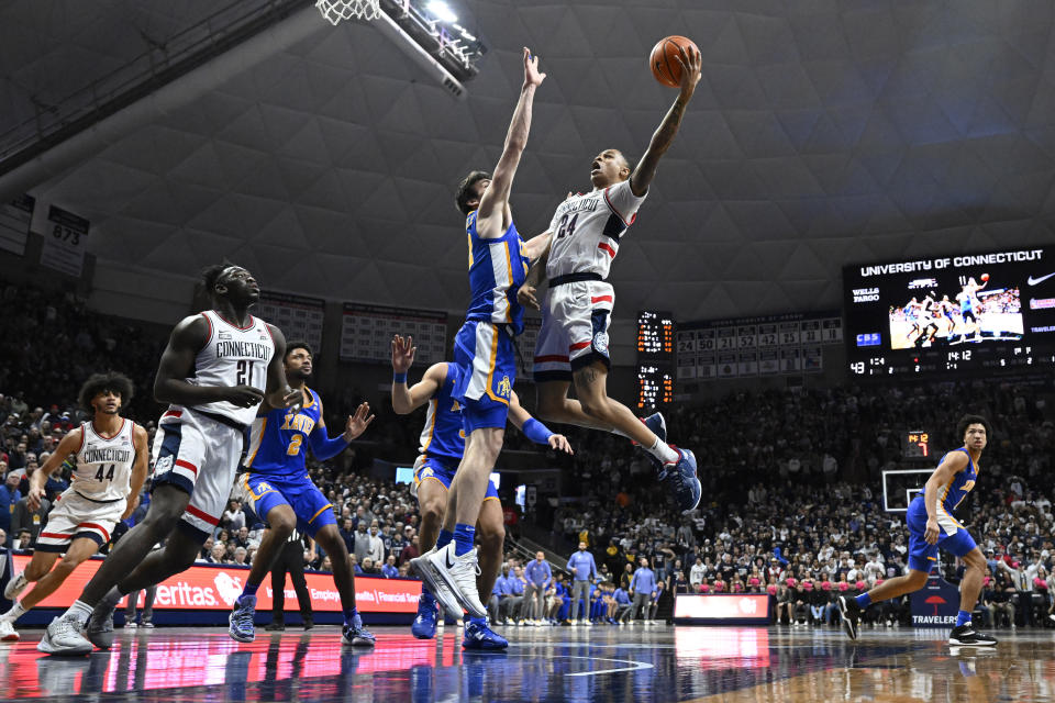 UConn's Jordan Hawkins (24) goes up to the basket against Xavier's Zach Freemantle in the second half of an NCAA college basketball game, Wednesday, Jan. 25, 2023, in Storrs, Conn. (AP Photo/Jessica Hill)